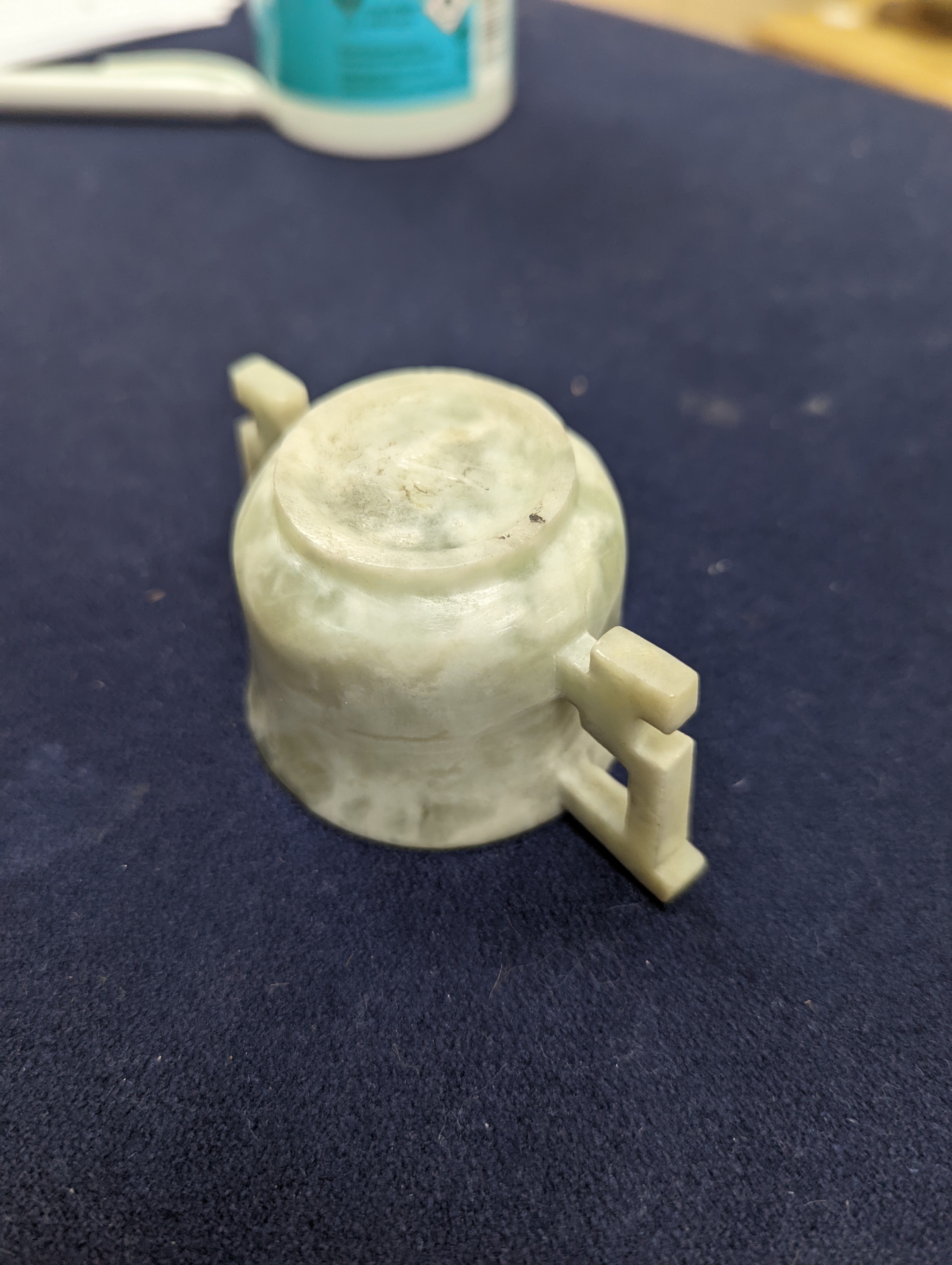A Chinese jade belt hook, 12.5cm an archer's ring and figure, a stone cup and a glass snuff bottle